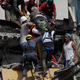 An injured man is pulled out of a building that collapsed during an earthquake in the Roma Norte neighborhood of Mexico City